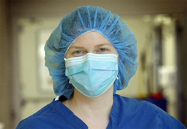 Employee wearing a mask in a hallway